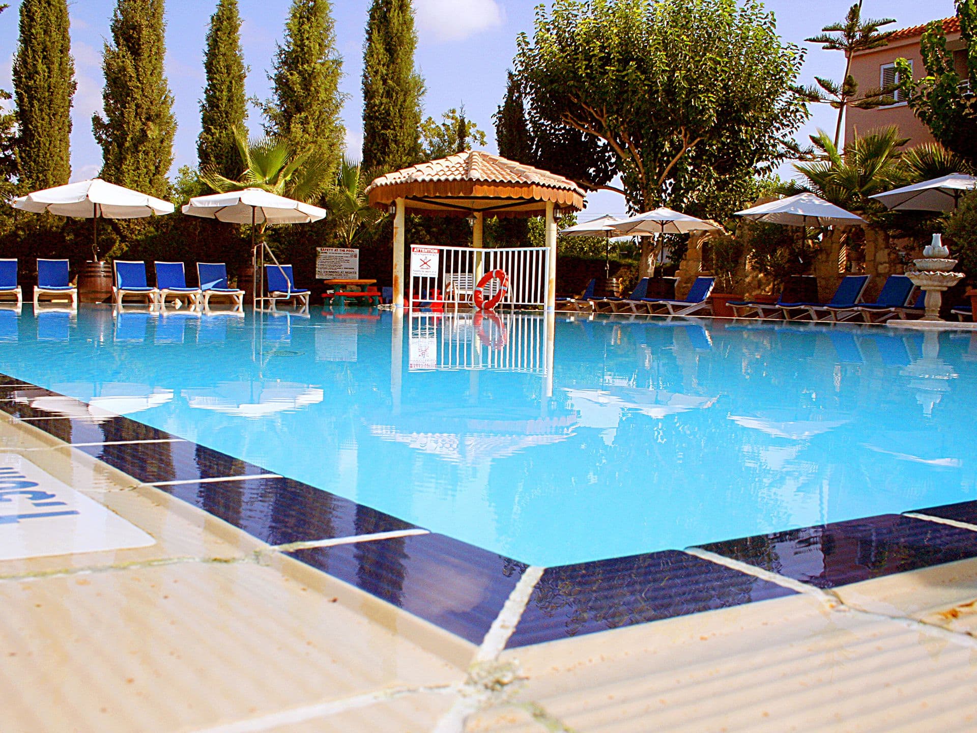 A serene sanctuary in our poolside relaxation area, nestled amidst the beauty of our sprawling gardens.