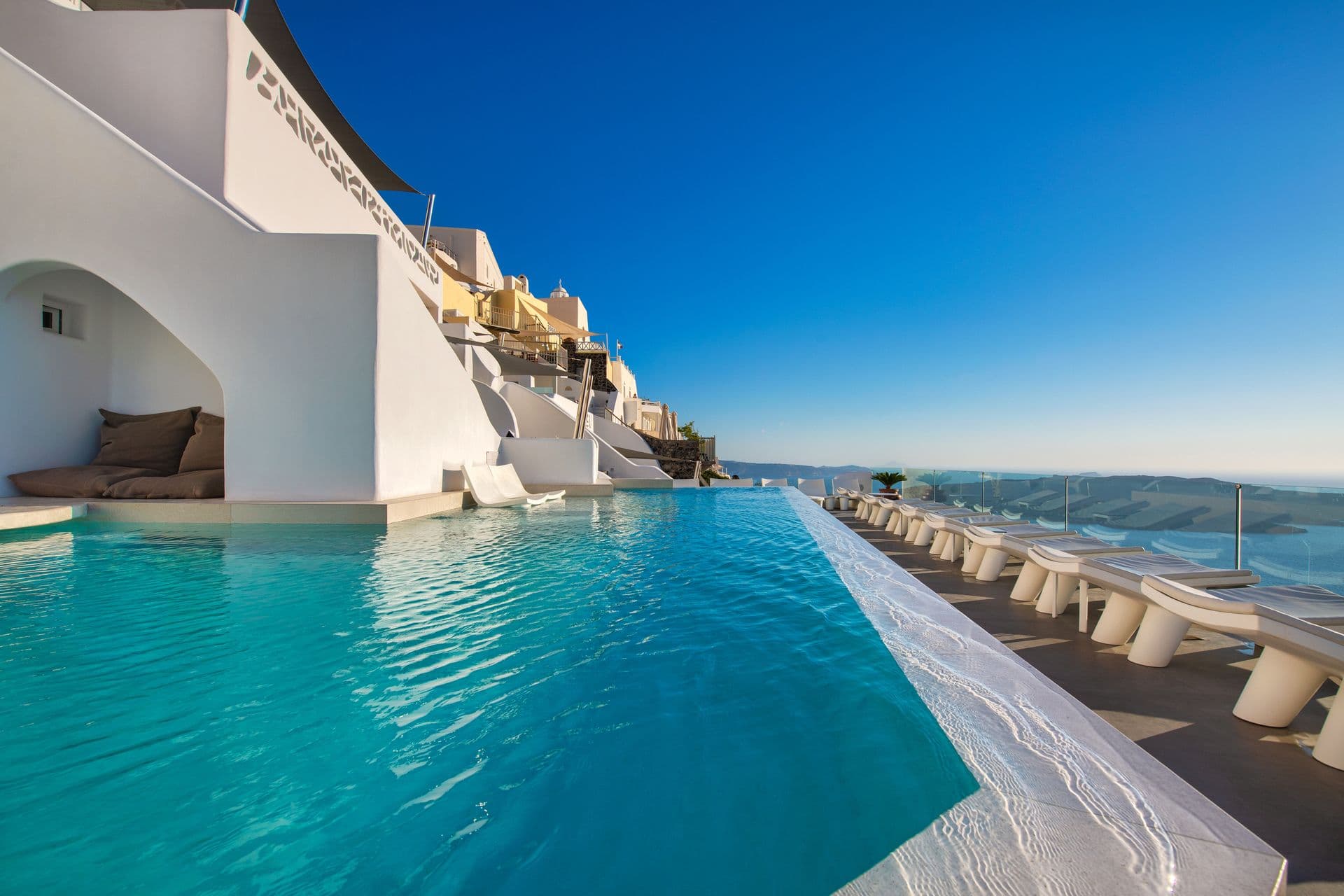 Our infinity heated swimming pool on the cliffs of the caldera
