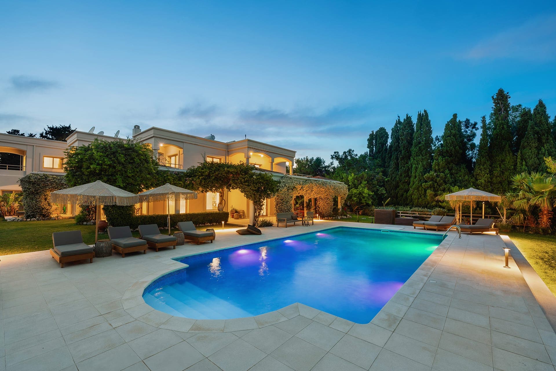 Luxury villa with private swimming pool at sunset