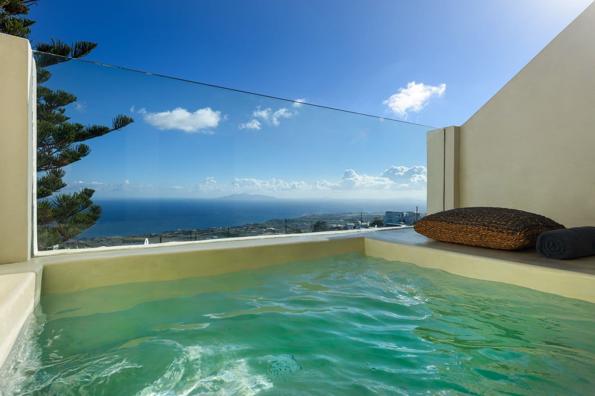 Outdoor heated jacuzzi with breathtaking view of the deep blue Aegean Sea