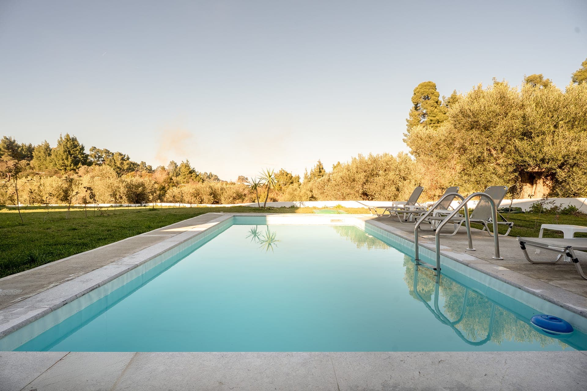 Luxury private pool villa surrounded by olive groves and peaceful Mediterranean scenery in Halkidiki, Greece.
