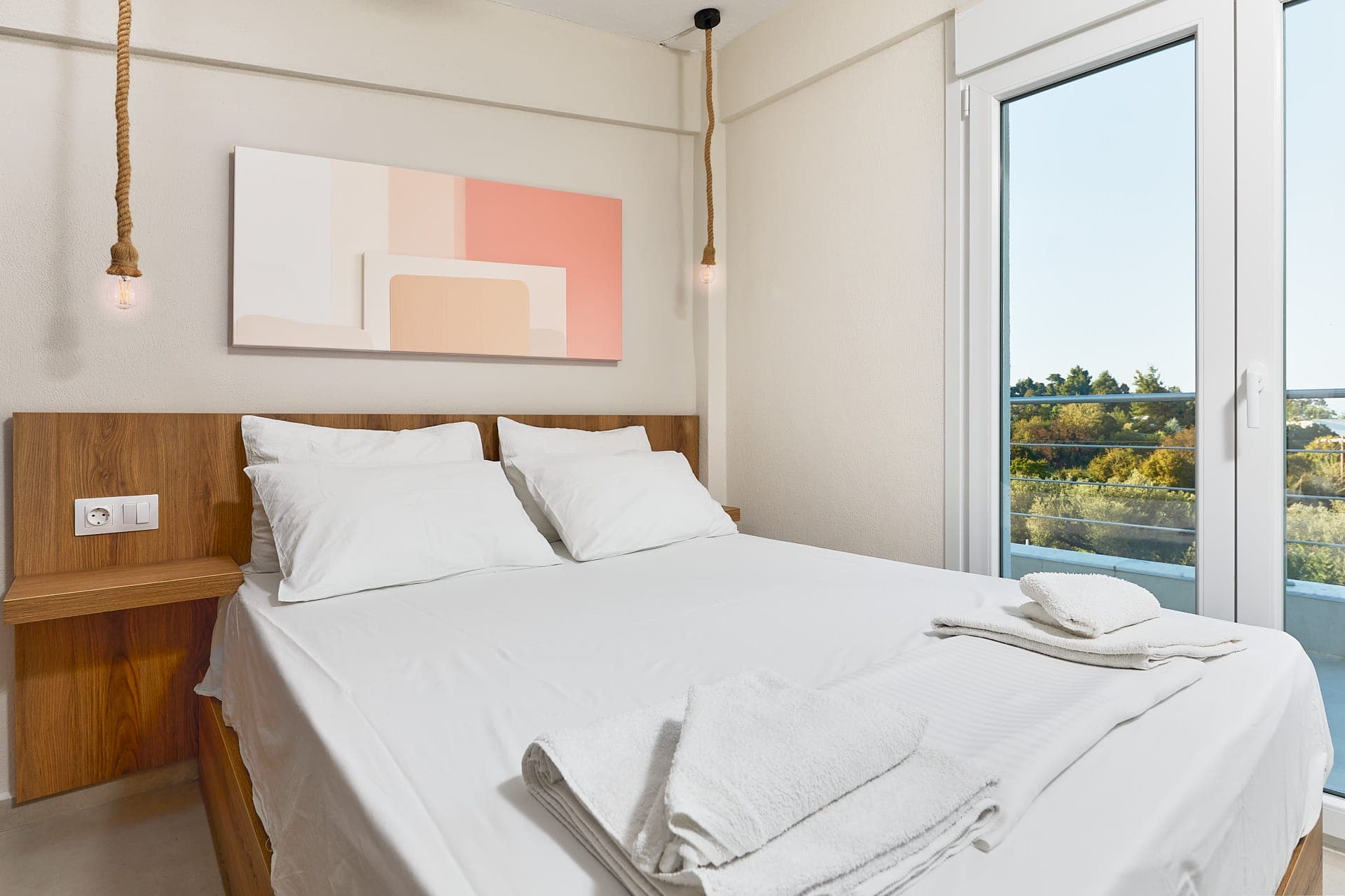 Elegant luxury villa bedroom with private balcony views, calming natural light, and peaceful Mediterranean atmosphere in Halkidiki.