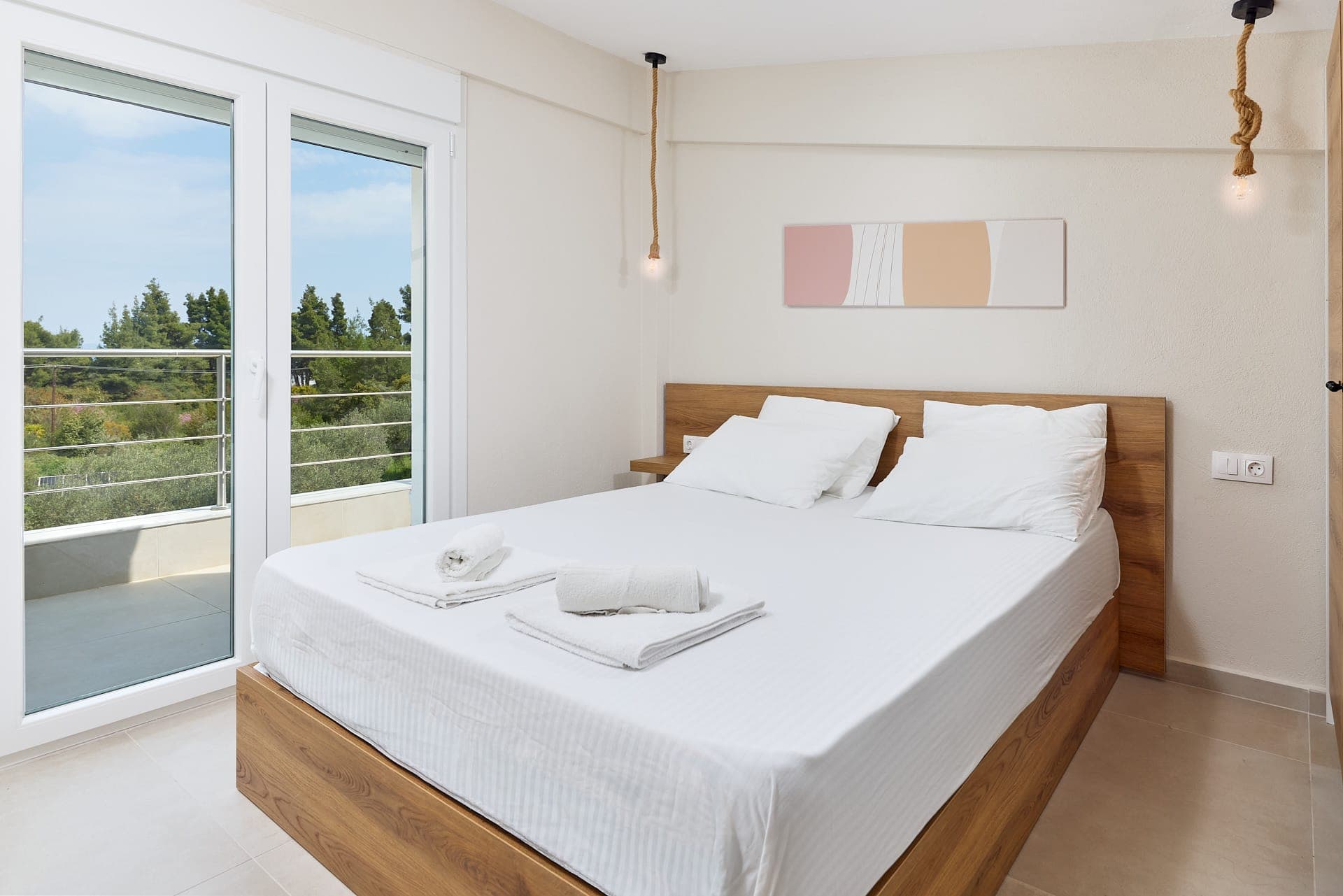 Wake up to peaceful balcony views, natural light, and refined Mediterranean comfort in this luxury villa bedroom in Halkidiki.