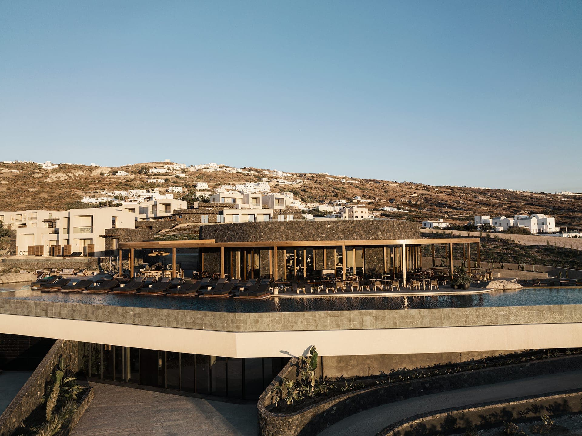 The architecture and design serve as a profound tribute to the island's natural beauty, drawing inspiration from the majestic volcano. They deftly harness timeless forces—water, light, and air—fashioning a contemporary marvel immersed in historical allure