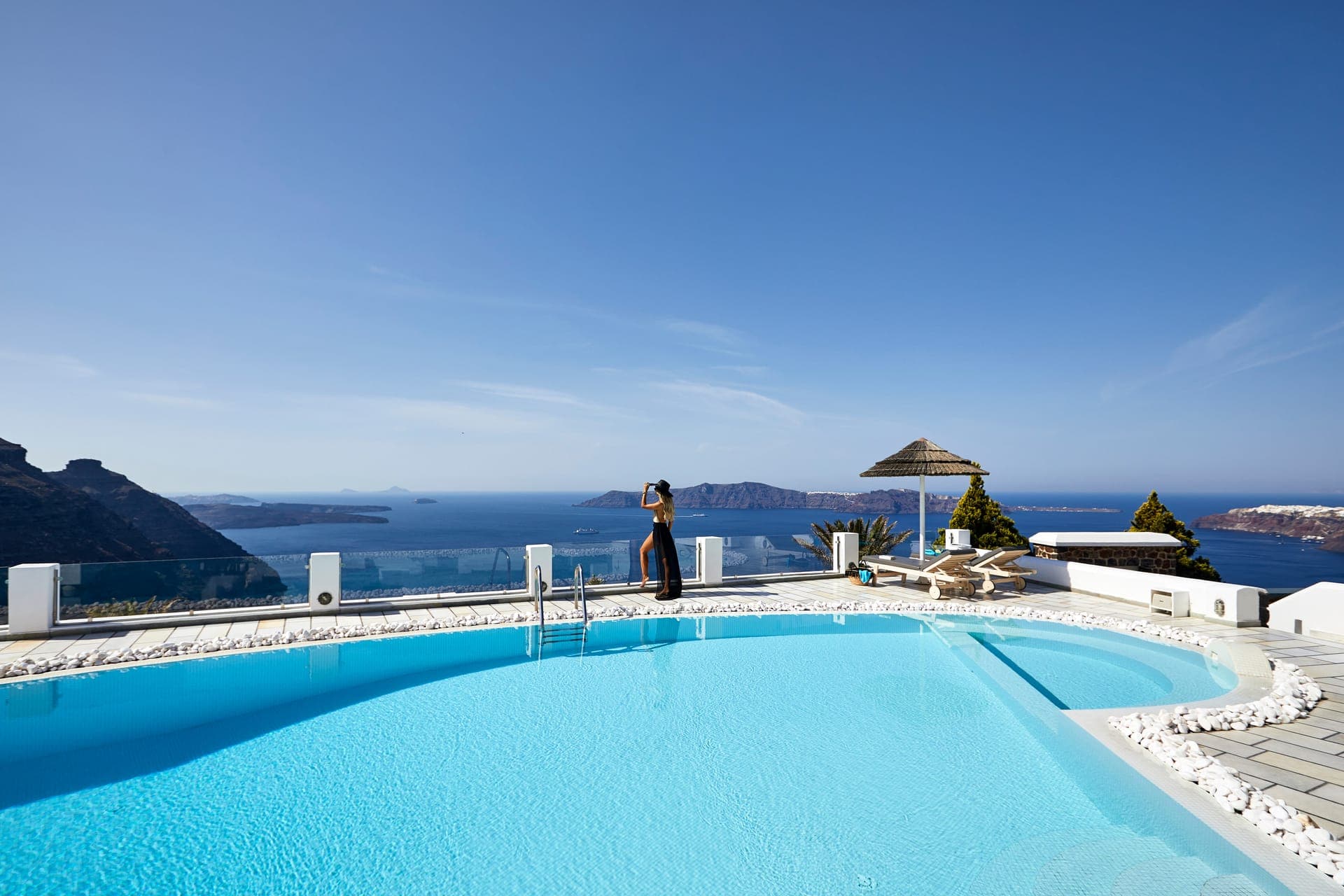 Our heated swimming pool has an amazing view to the Caldera cliffas and the famous volcano of Santorini