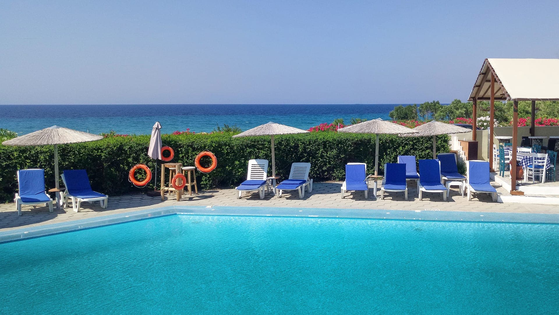 Beachfront swimming pool with stunning sea views at Skion Palace Beach Hotel in Kassandra, Halkidiki.