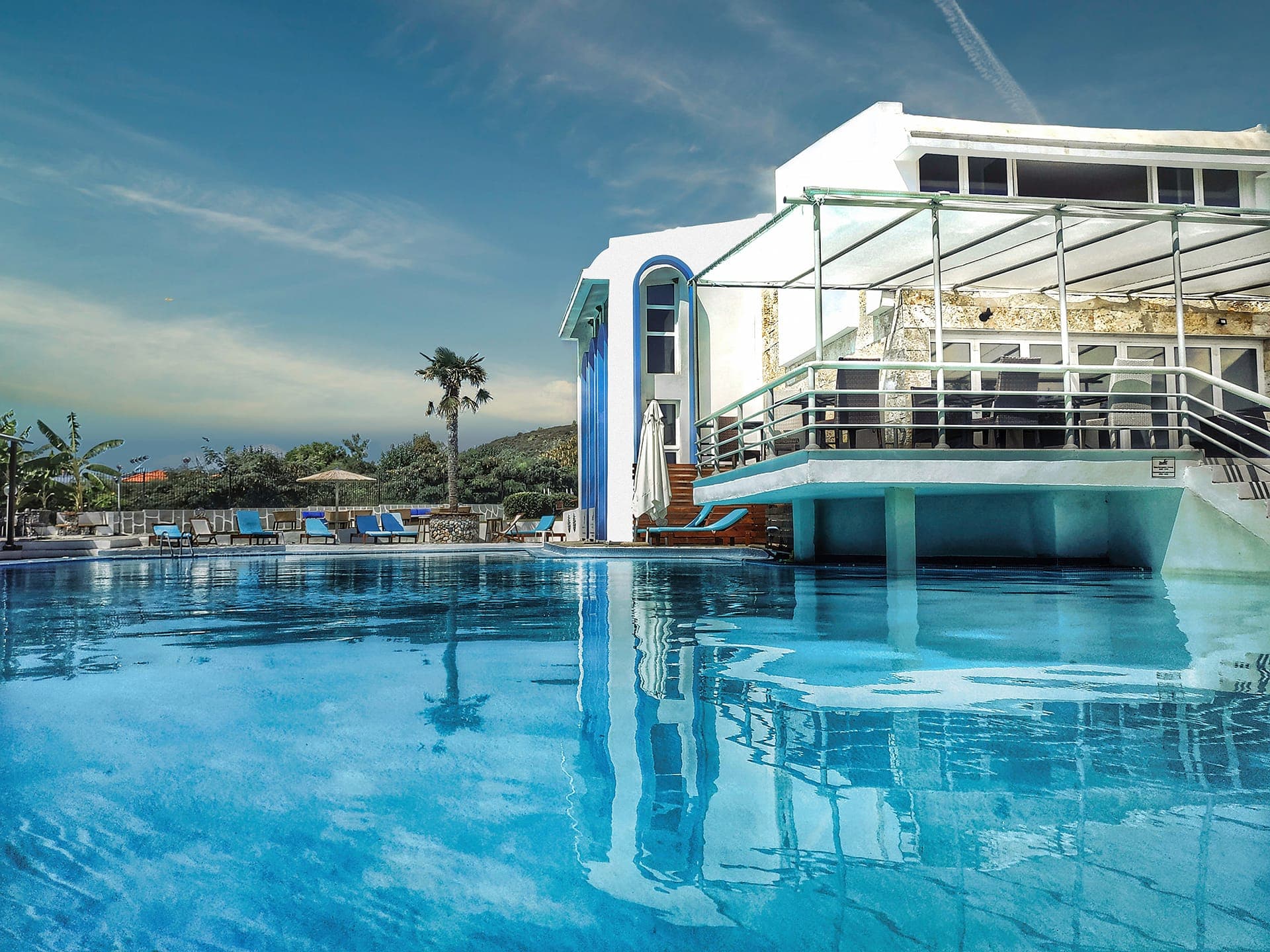 Luxury beachfront pool experience at Skion Palace Beach Hotel in Kassandra, Halkidiki, Greece.