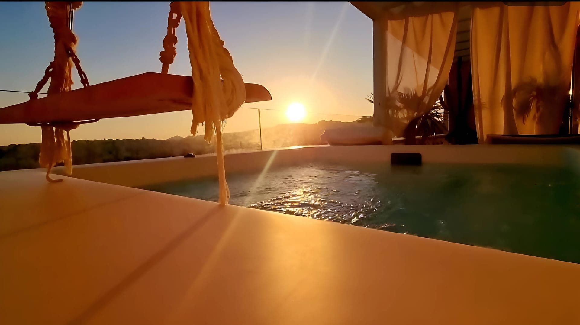 Imagine yourself swinging gently as the sun sets over the Grecian hills, your private jacuzzi shimmering in the golden light.

This isn't just a vacation; it's a transcendent escape into opulence.