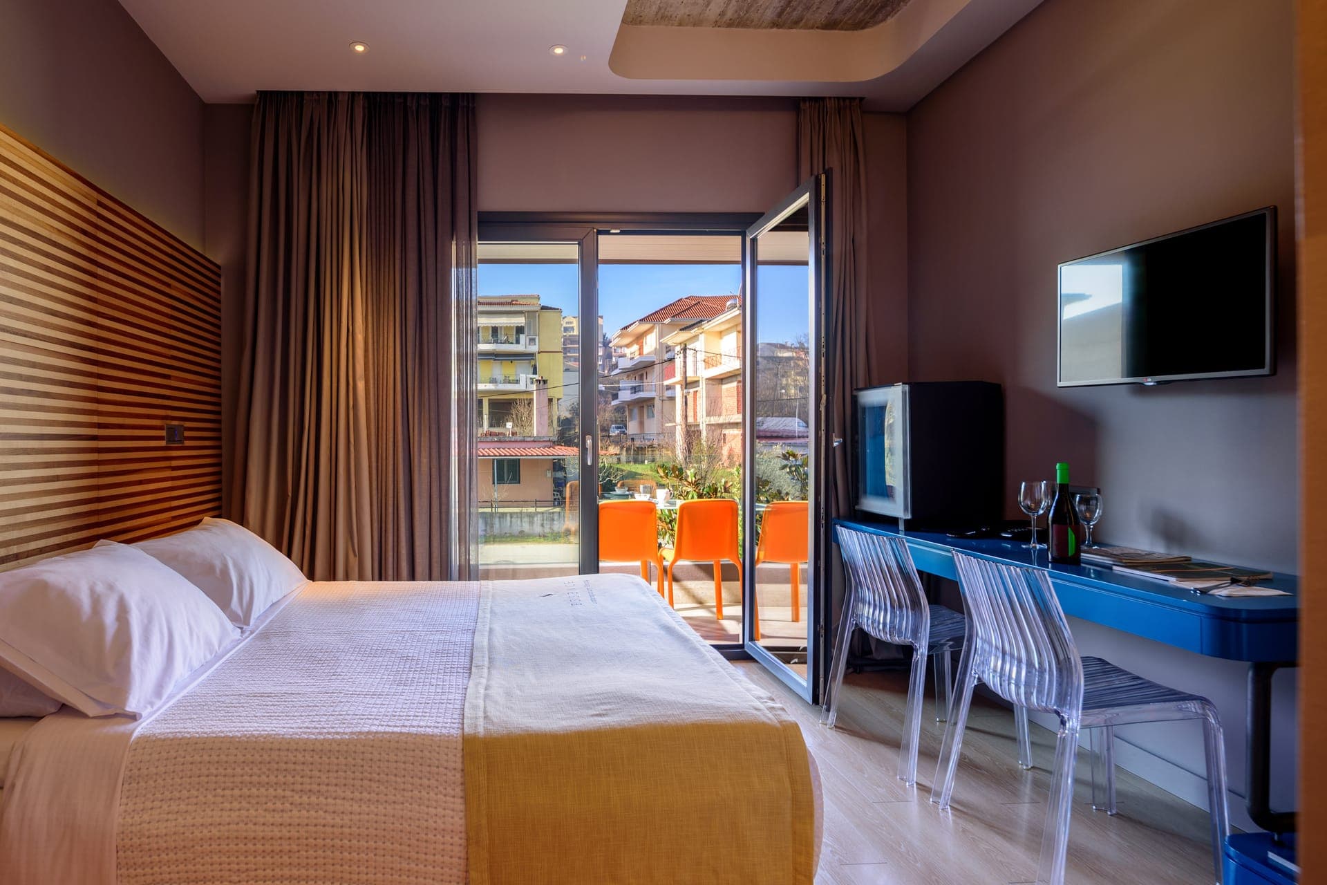 Cozy bedroom with modern decor and private balcony with city view
