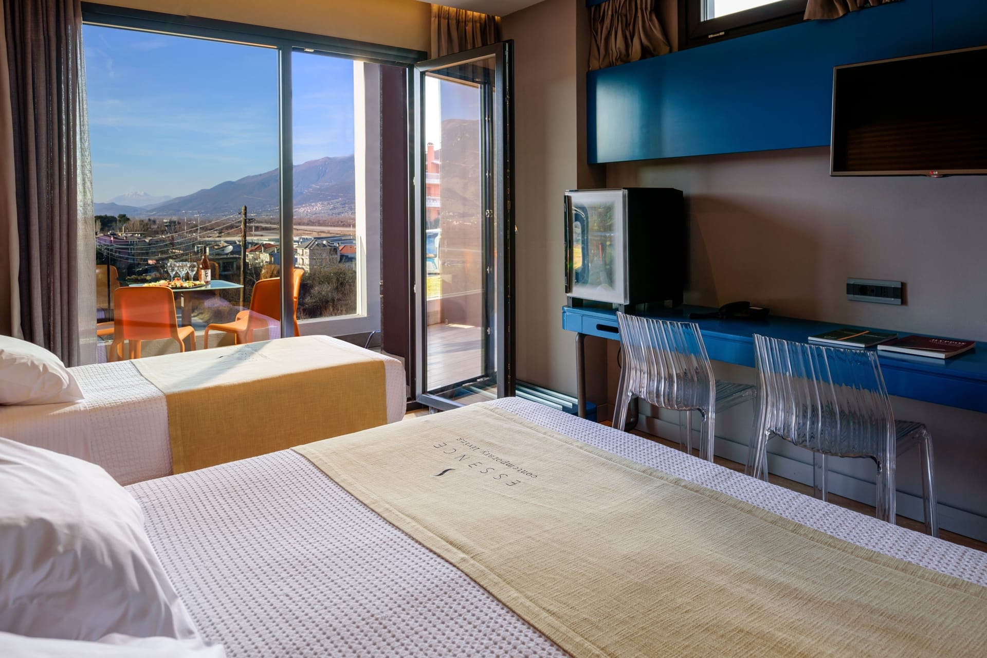 Spacious open plan bedroom with private veranda or balcony and mountain view