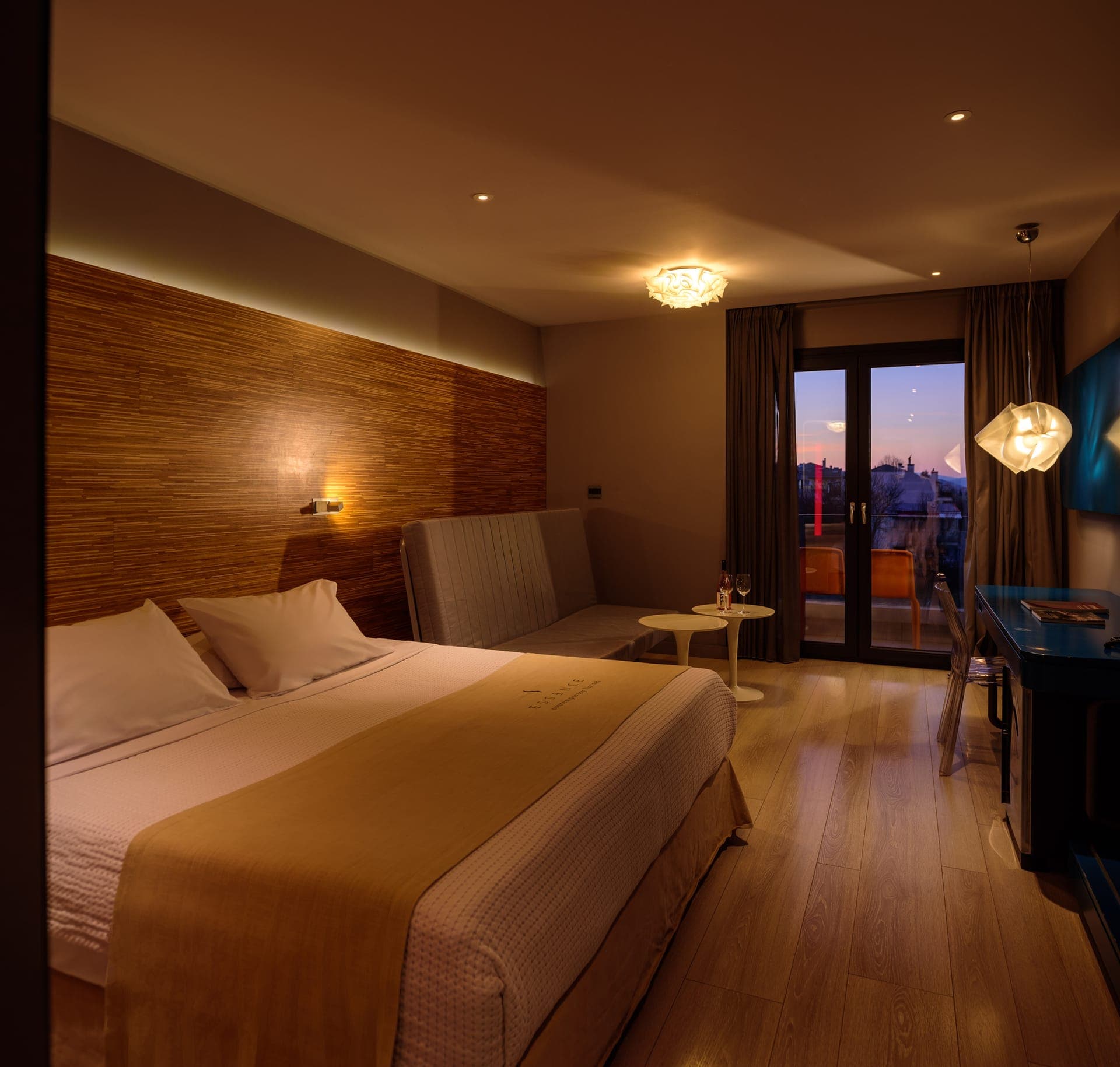 Spacious open plan bedroom with double bed that opens up to a private balcony or veranda