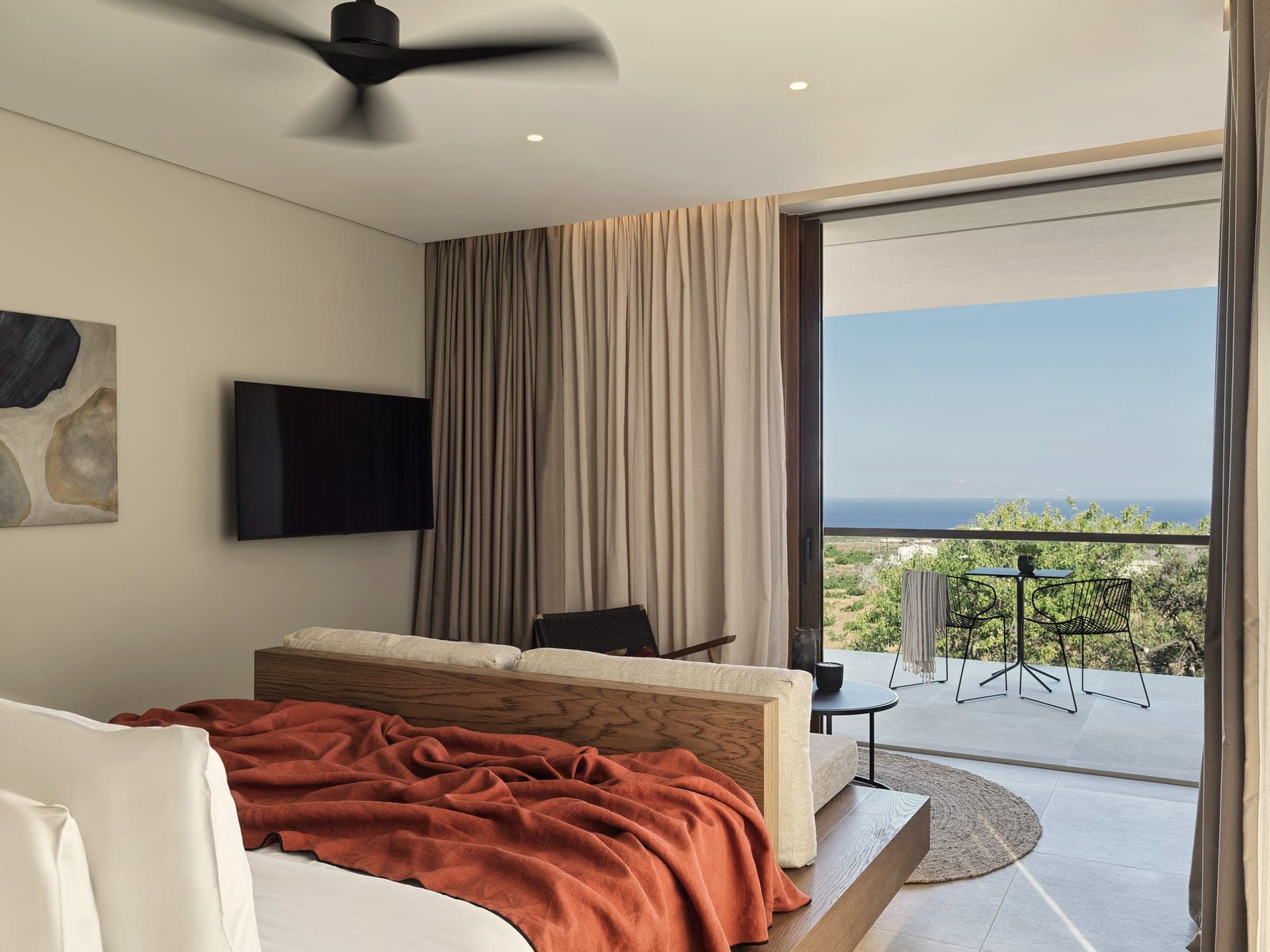 An impeccably designed sea-view suite of 30-40sqm (323-430 sqft) with Jacuzzi and an atmosphere of volcanic calm, where natural beauty blends seamlessly with elevated style amidst green vineyards and Aegean Sea views.