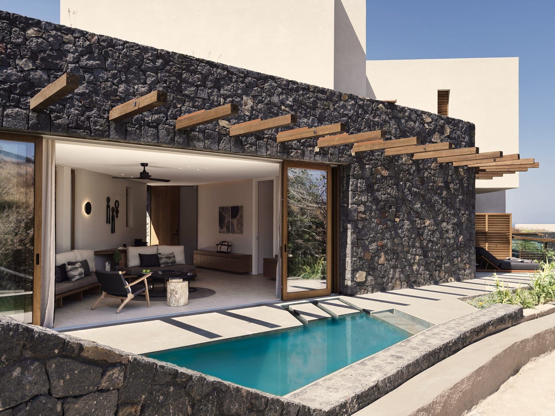 Experience Earthly tranquility within 77sqm (828 sqft) of a private sanctuary with a separate living room area including a sofa and an iconic private swimming pool.