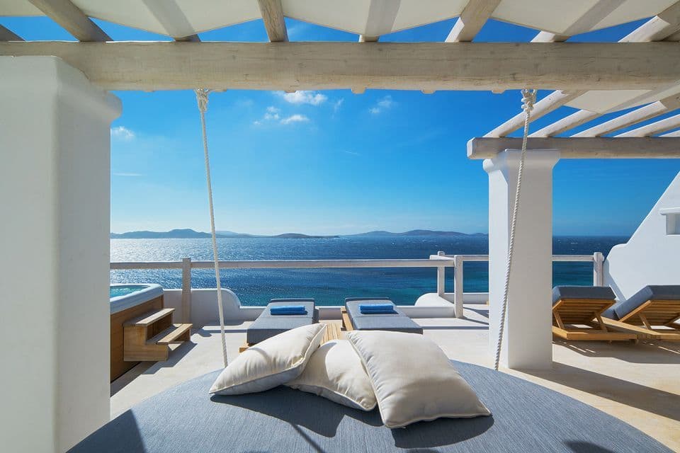 Executive Sea View Suite offers  sea view from the private terrace with a daybed under a traditional pergola.