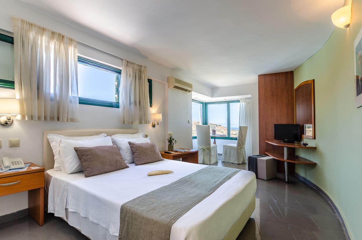 Bedroom and window screen with pool view and panoramic sea views.